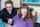 Father assists his autistic daughter with her classwork while using digital tablet at home