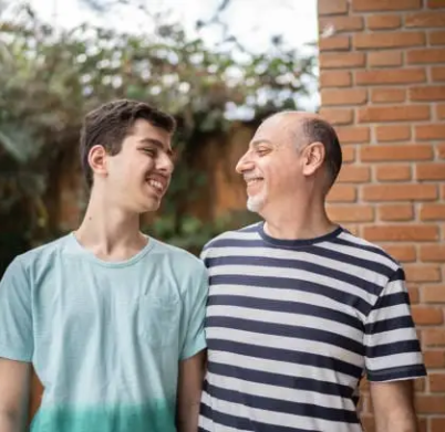 Father and son looking at each other at home